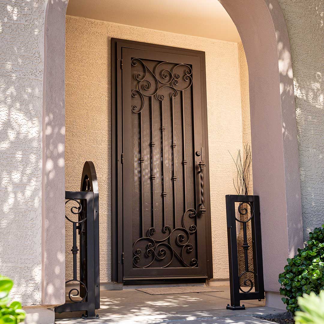 Front porch of a home showing a beautiful First Impression Ironworks Tuscan Iron Security Door
