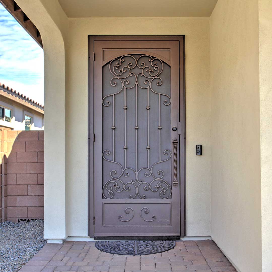 First Impression Ironworks security door with a beautiful iron scrollwork design