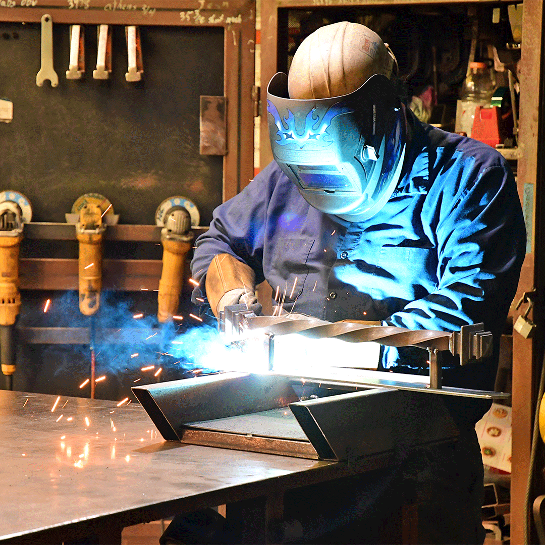 First Impression Ironworks employee welding a Iron Entry Door