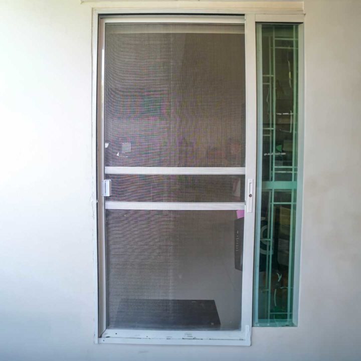 Front of a house with an aluminum screen door