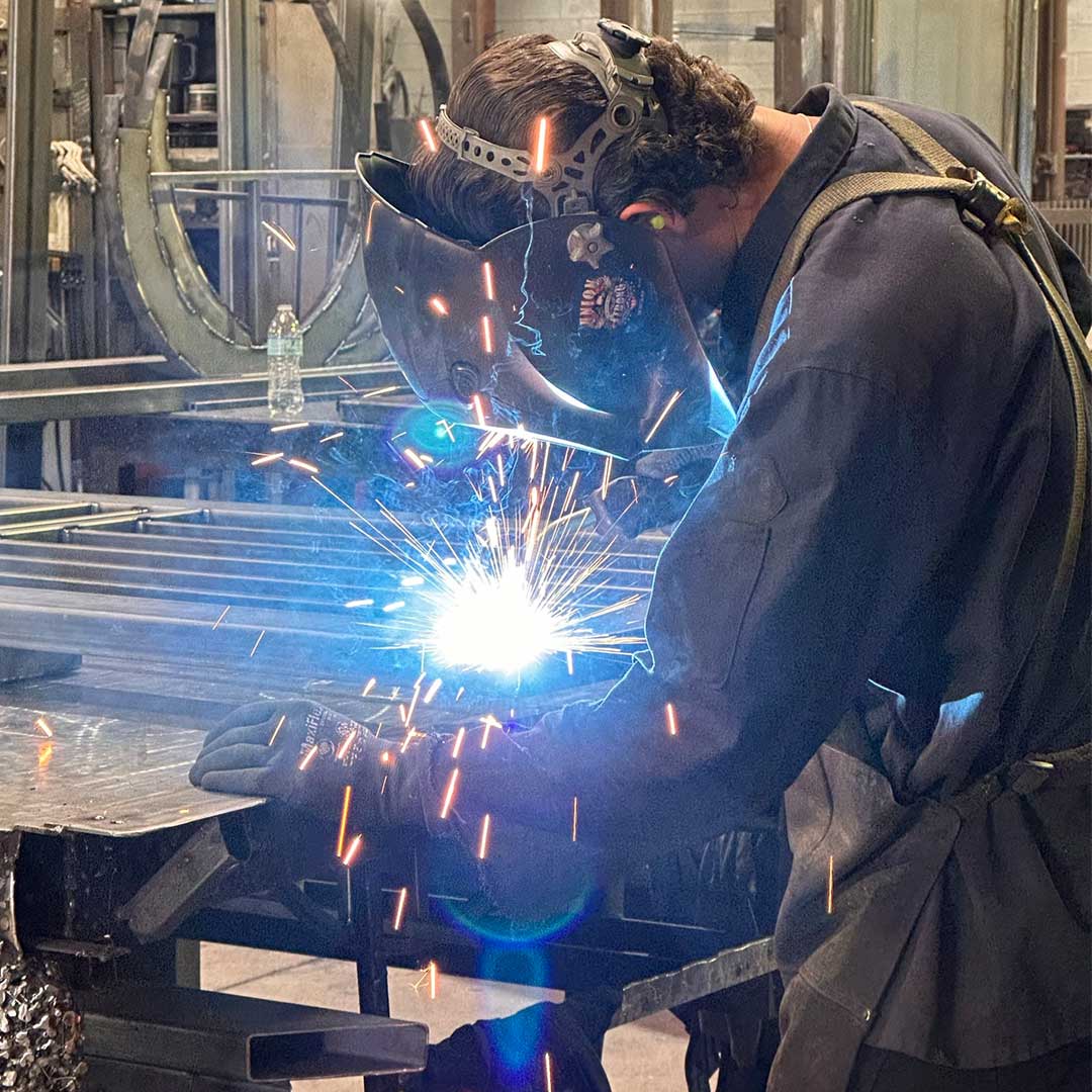 First Impression Ironworks welder working on an iron door