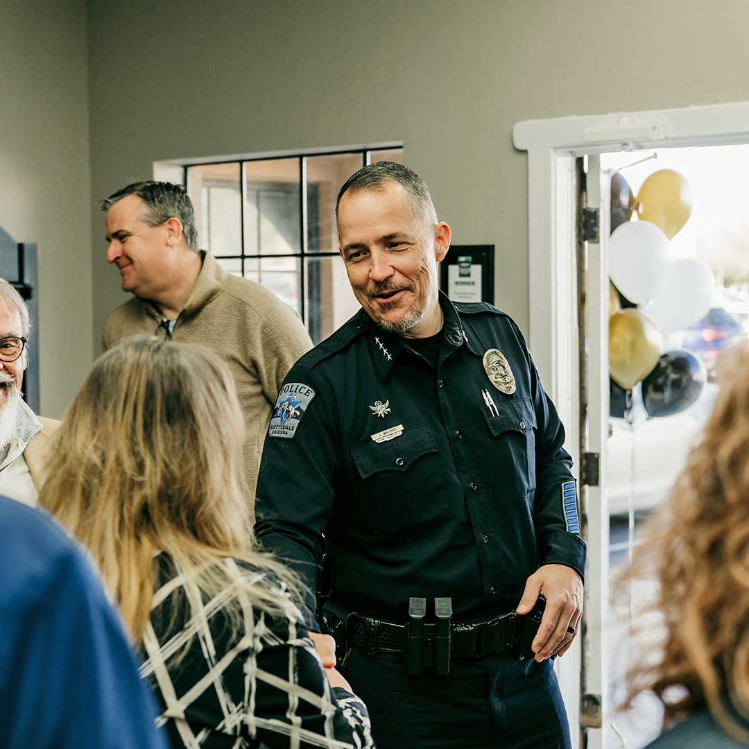 Scottsdale Chief of Police shaking hands with a member of the First Impression Ironworks team.