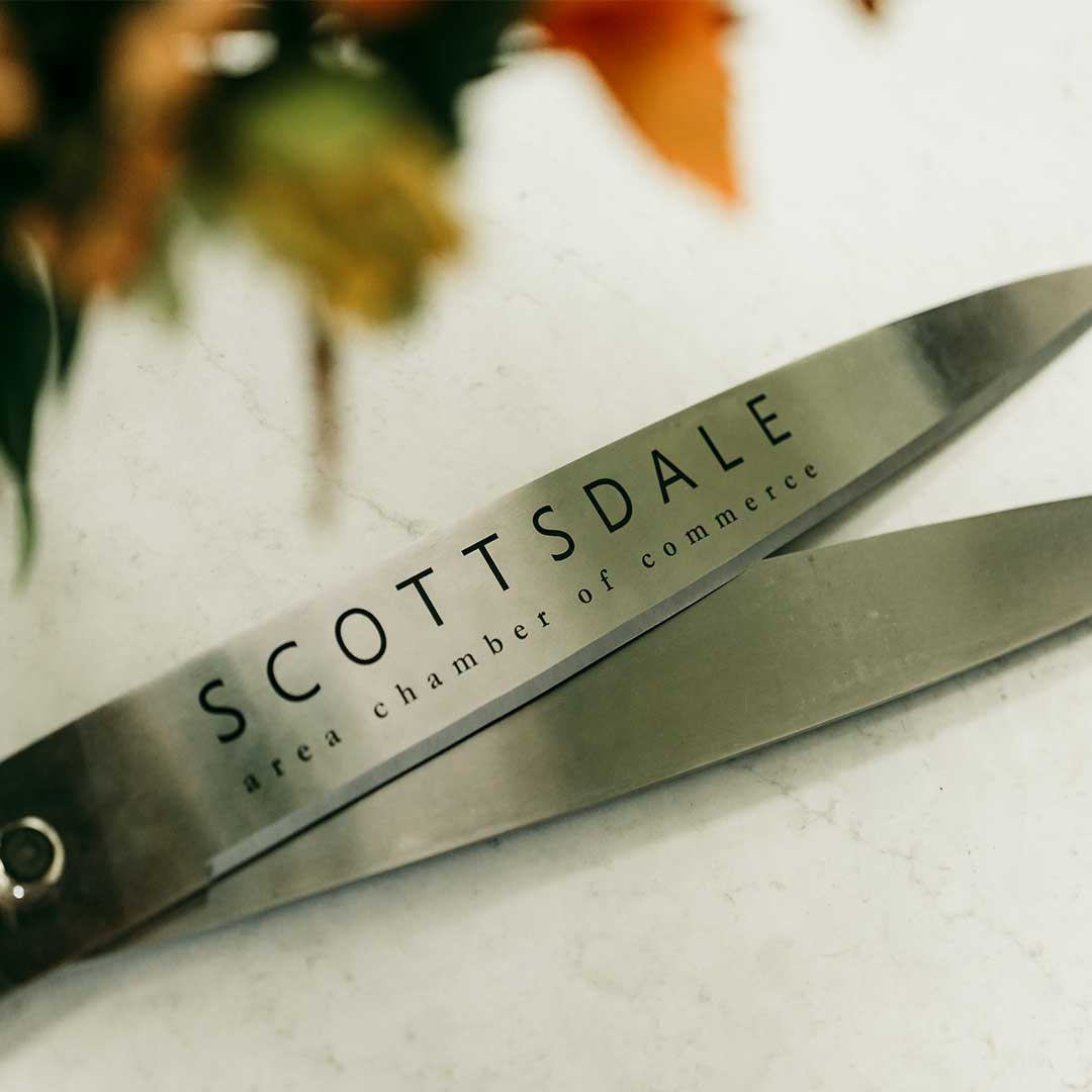 A close up of the scissors used for the ribbon cutting.  The scissors have the words "Scottsdale are chamber of commerce" engraved on them.