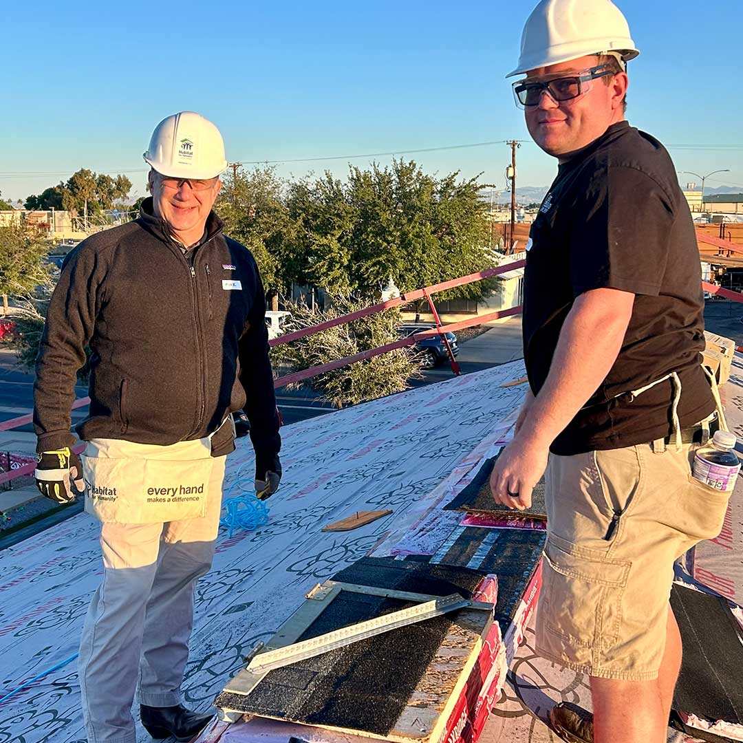 First Impression Ironworks team members working on the roof of a home being built