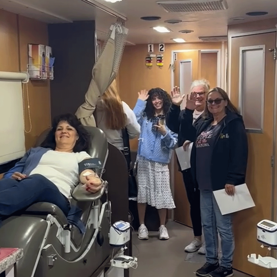 Group of First Impression Ironworks employees posing for a group picture in the American Red Cross mobile blood donation bus.