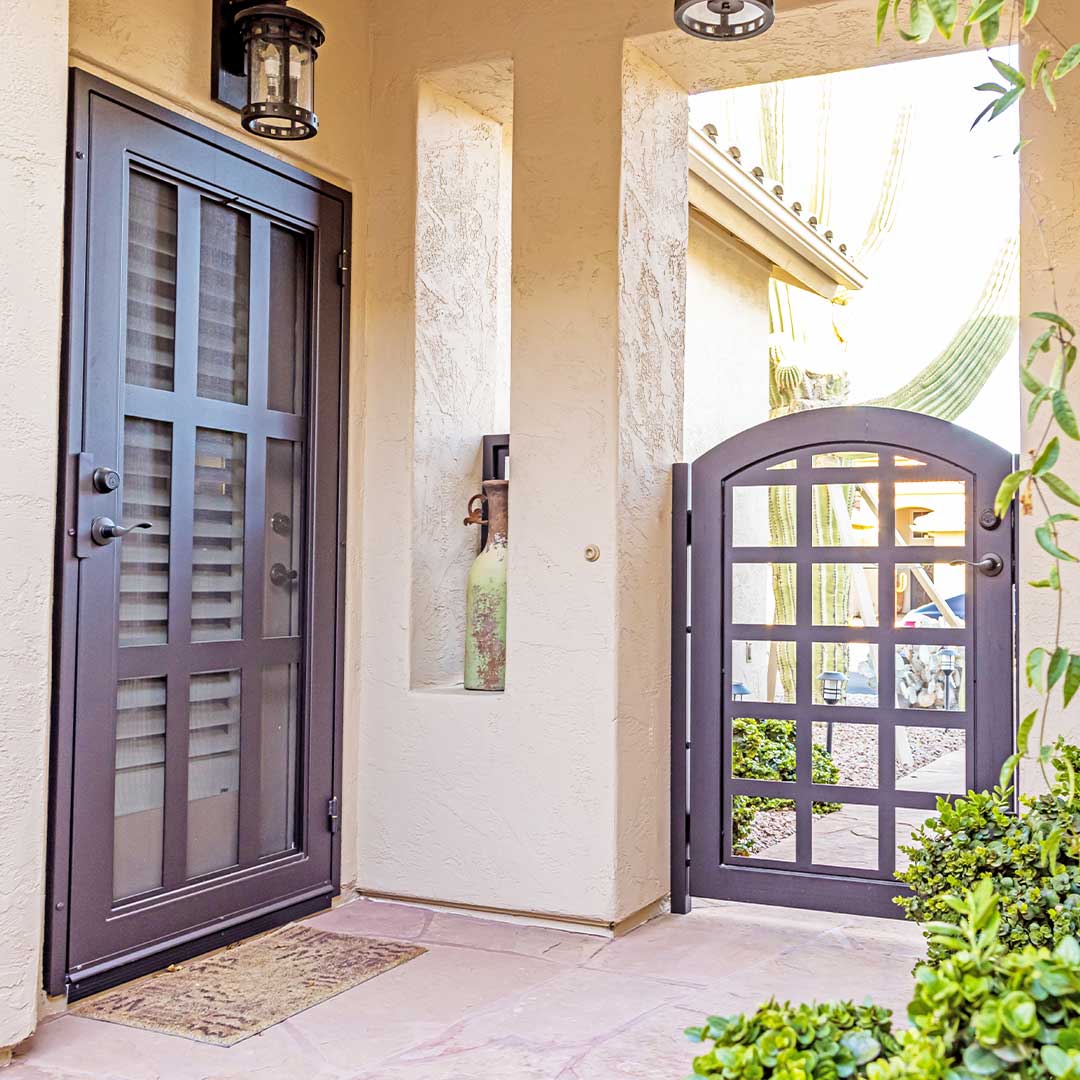 Entry of a home showing off the matching custom First Impression Ironworks entry gate and Iron Entry Door.