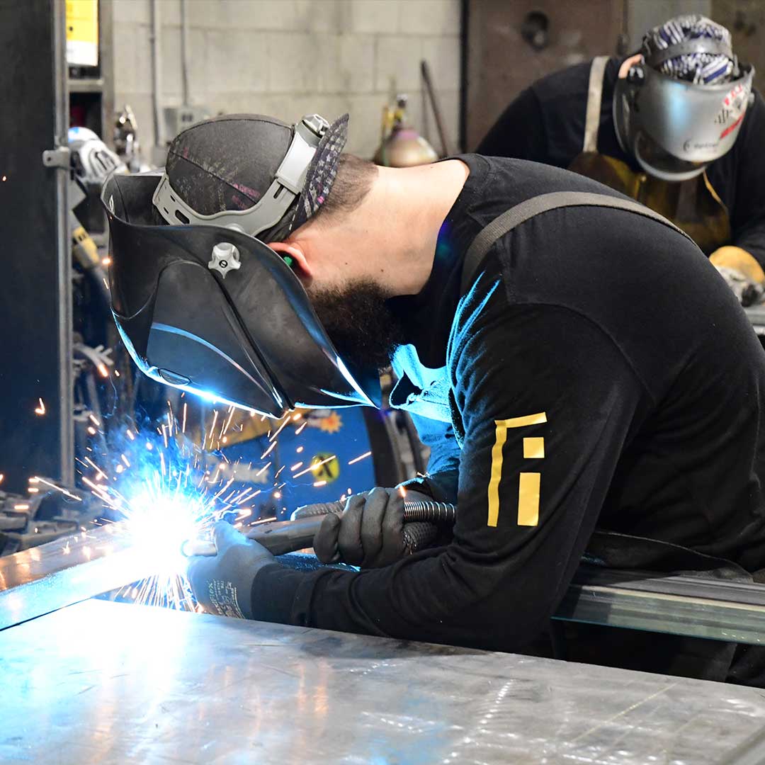 First Impression Ironworks welder working on a custom iron door