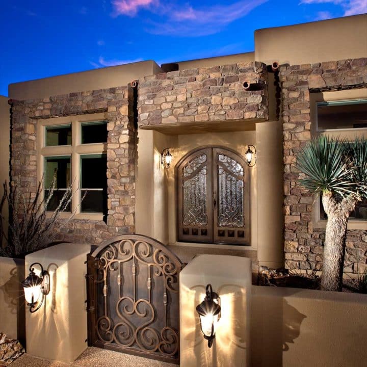 Exterior of a home illuminated by multiple outdoor lights